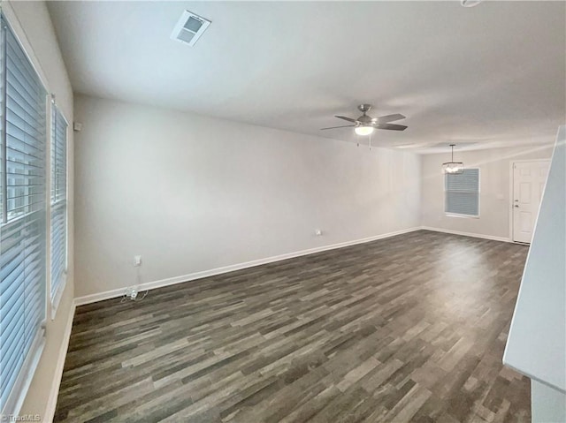 empty room featuring dark hardwood / wood-style floors and ceiling fan