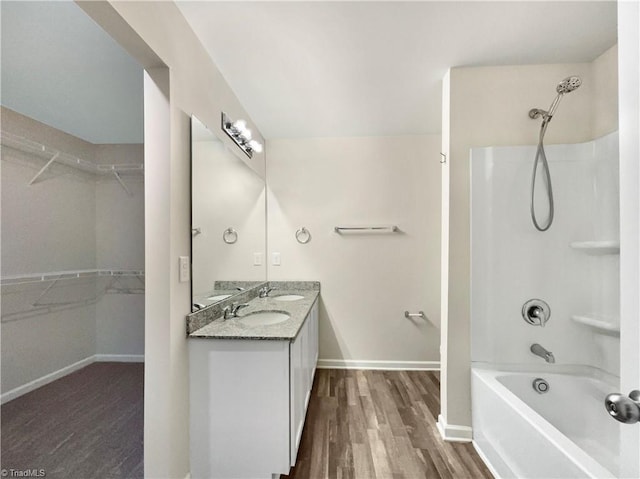 bathroom featuring vanity, wood-type flooring, and bathtub / shower combination