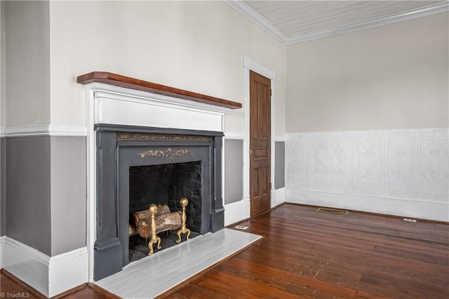 interior details featuring a fireplace, crown molding, wood finished floors, and visible vents