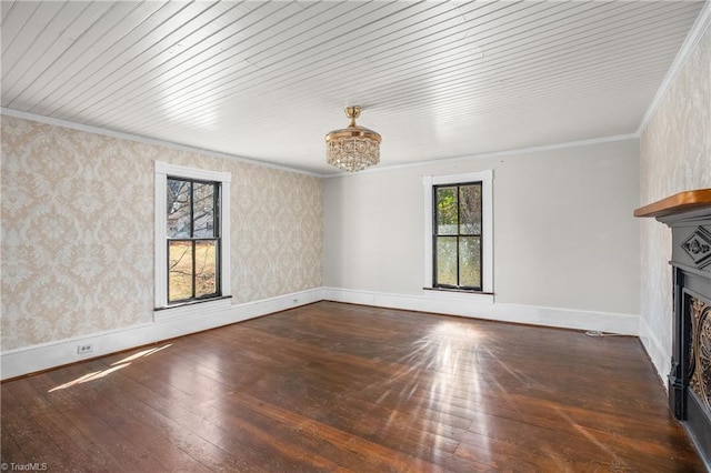 unfurnished living room with wallpapered walls, baseboards, ornamental molding, hardwood / wood-style floors, and a fireplace