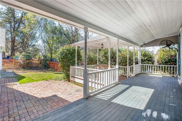 wooden deck with a patio area and fence