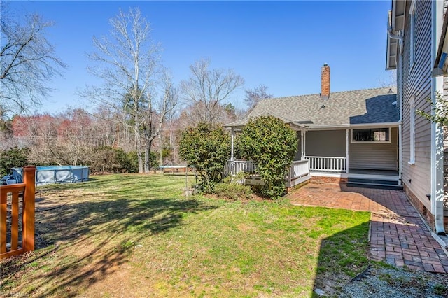 view of yard featuring a patio area and an outdoor pool