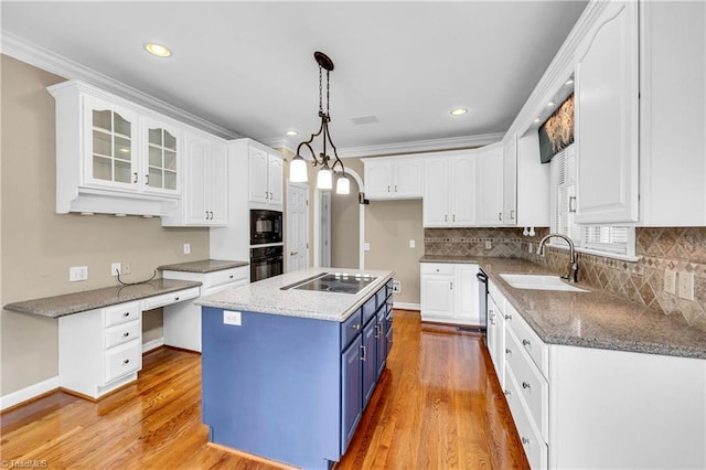 608 Greyrock Rd, Whitsett, NC 27377 - kitchen featuring blue cabinetry, a sink, black appliances, white cabinets, and decorative backsplash