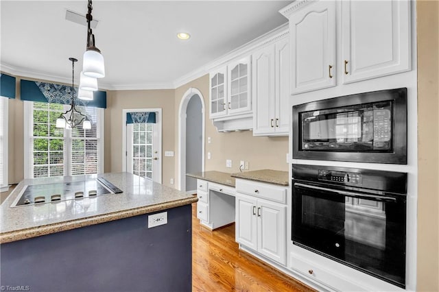 608 Greyrock Rd, Whitsett, NC 27377 - kitchen with black appliances, ornamental molding, white cabinets, arched walkways, and decorative light fixtures