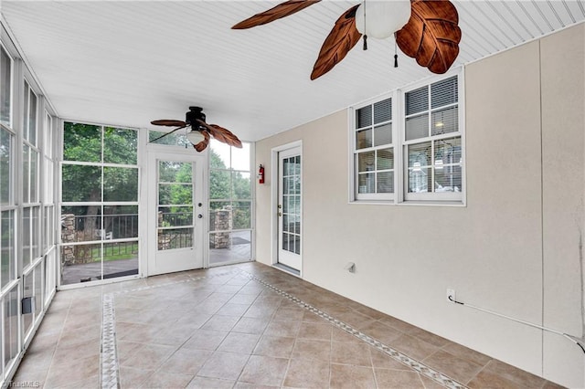 608 Greyrock Rd, Whitsett, NC 27377 - unfurnished sunroom with ceiling fan, floor to ceiling windows, inlaid floor details, and tile patterned floors