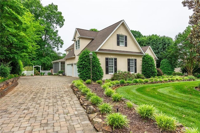 608 Greyrock Rd, Whitsett, NC 27377 - traditional-style home featuring stucco siding and decorative driveway