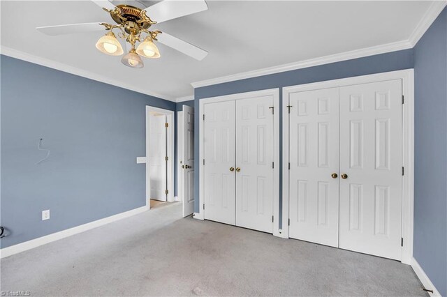 608 Greyrock Rd, Whitsett, NC 27377 - unfurnished bedroom featuring multiple closets, carpet, baseboards, crown molding, and a ceiling fan