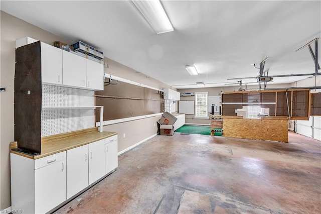 608 Greyrock Rd, Whitsett, NC 27377 - garage featuring a garage door opener and baseboards