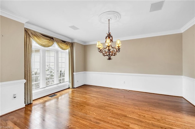 608 Greyrock Rd, Whitsett, NC 27377 - spare room with a chandelier, wood finished floors, crown molding, and baseboards