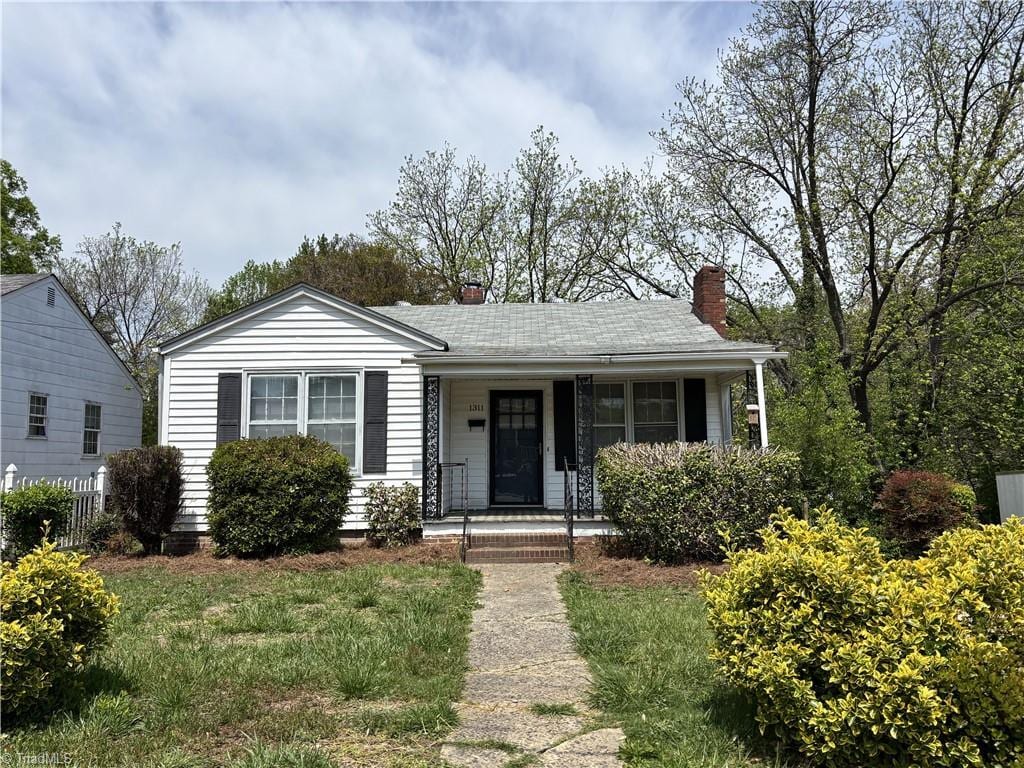1311 Verdun St, Winston-Salem, NC 27107 - view of front of property with a chimney, fence, and a porch