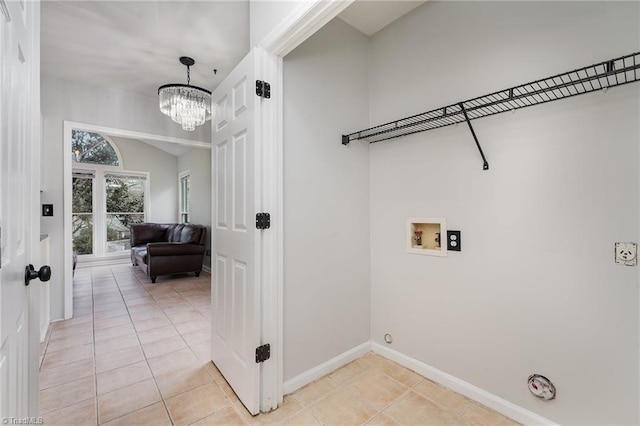 laundry room featuring a chandelier, hookup for a washing machine, light tile patterned floors, and gas dryer hookup