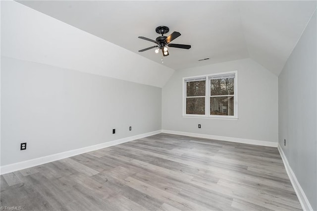 additional living space with ceiling fan, light hardwood / wood-style floors, and vaulted ceiling