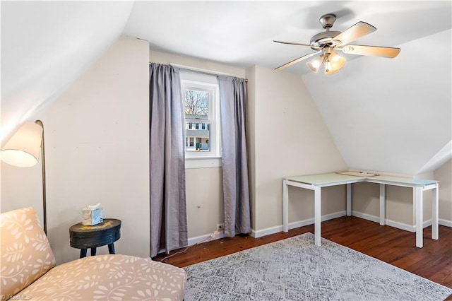 interior space featuring dark hardwood / wood-style floors, vaulted ceiling, and ceiling fan