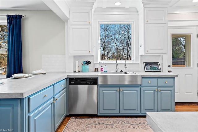 kitchen featuring blue cabinetry, dishwasher, and white cabinets