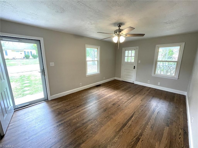 interior space with ceiling fan, dark hardwood / wood-style floors, and a textured ceiling