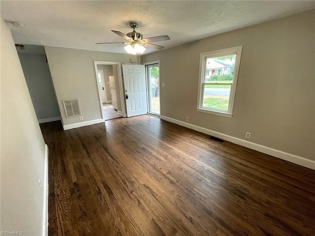 empty room featuring ceiling fan and dark hardwood / wood-style floors