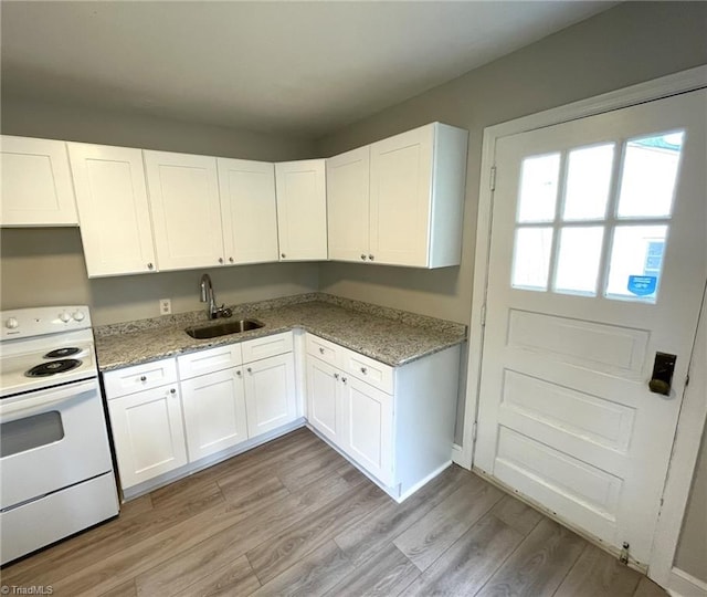 kitchen featuring sink, white cabinetry, white range with electric stovetop, light hardwood / wood-style flooring, and light stone counters