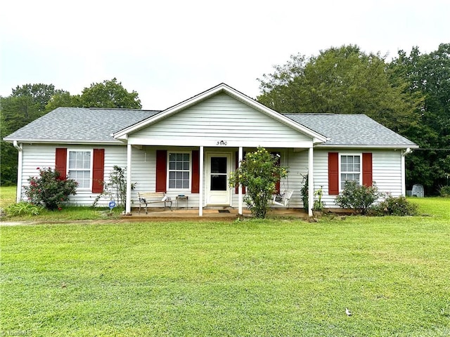 ranch-style house with a porch and a front lawn