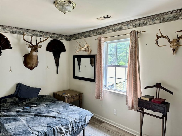 bedroom with hardwood / wood-style flooring