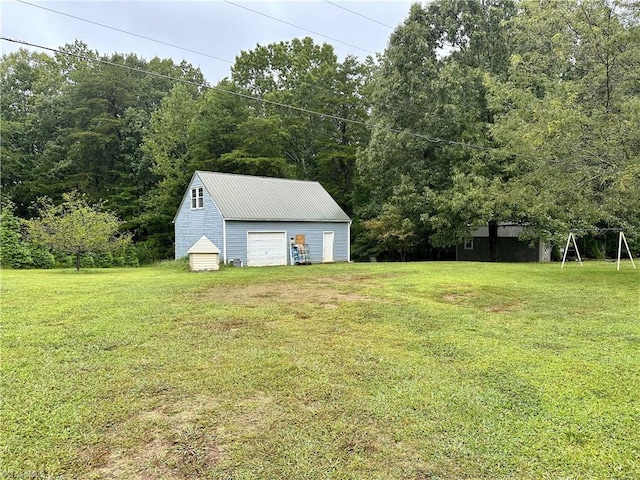 view of yard featuring an outdoor structure and a garage