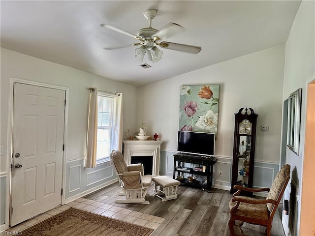 sitting room featuring light hardwood / wood-style flooring, lofted ceiling, and ceiling fan