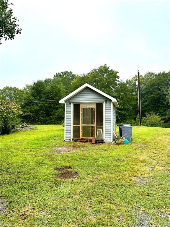 view of outbuilding with a lawn