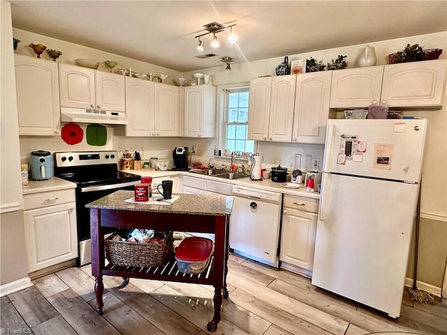 kitchen with light wood-type flooring, white appliances, white cabinetry, and sink