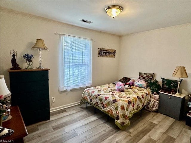 bedroom with light hardwood / wood-style floors