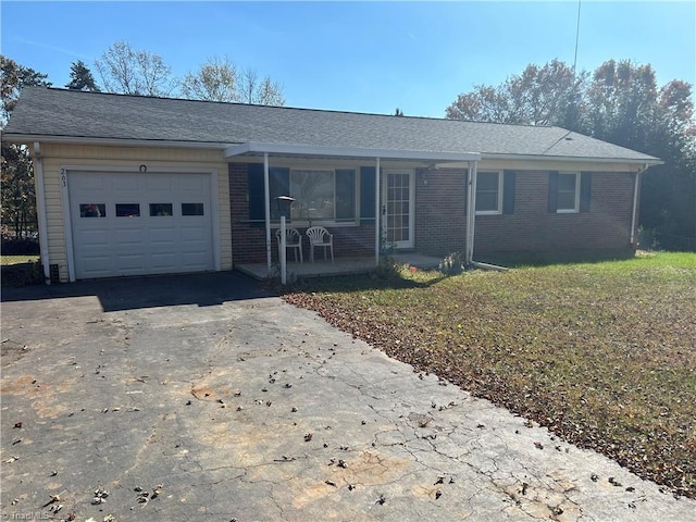 single story home featuring a front yard and a garage