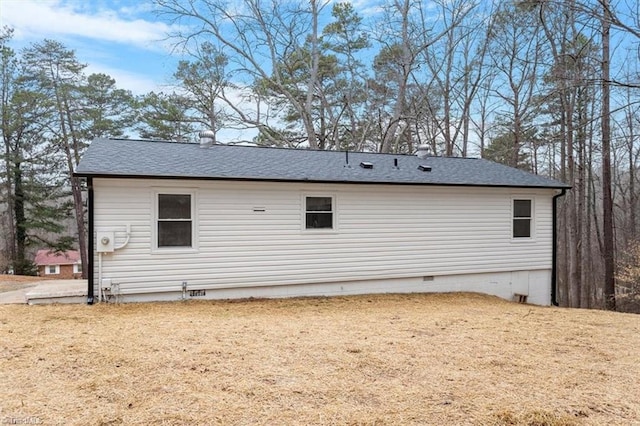 view of side of home featuring a yard