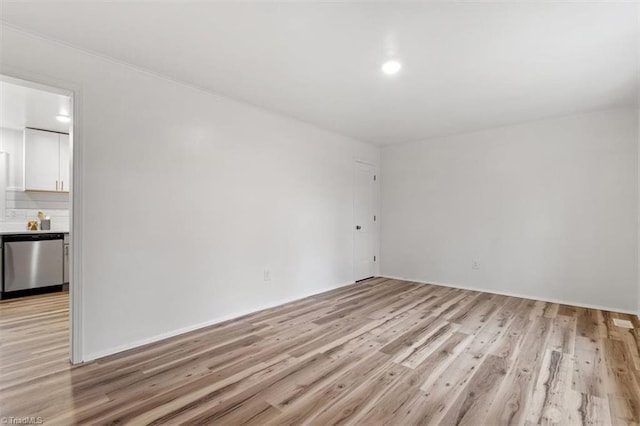 empty room with light hardwood / wood-style flooring