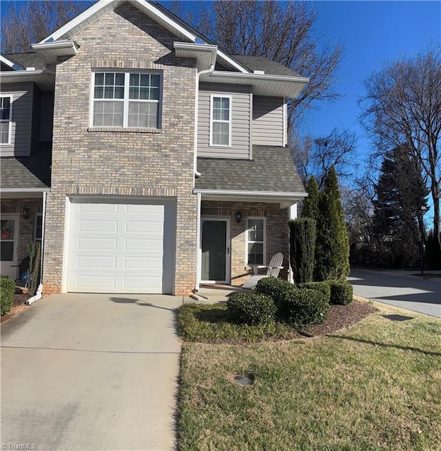 view of front of house with brick siding, driveway, an attached garage, and roof with shingles