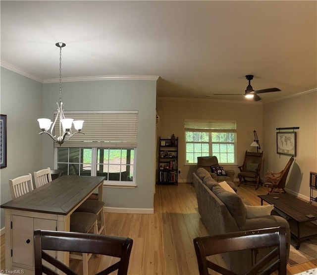 living area with plenty of natural light, light wood-style flooring, and baseboards