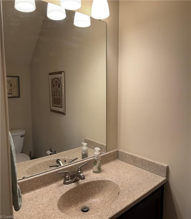 half bath with vanity and toilet