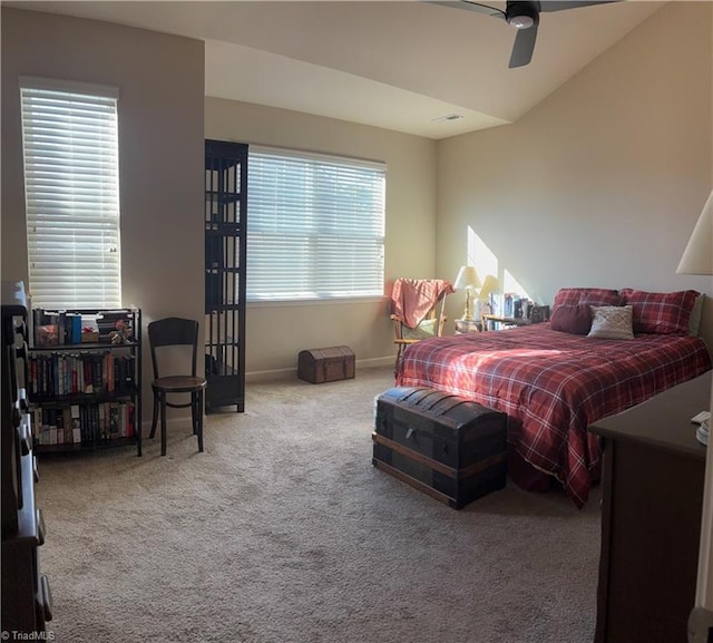 carpeted bedroom featuring vaulted ceiling, ceiling fan, and baseboards