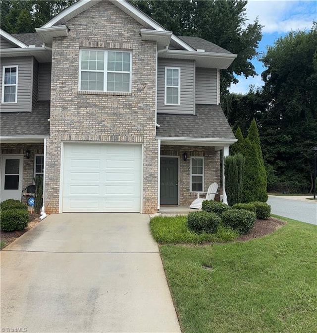 view of front of home with an attached garage, concrete driveway, and brick siding