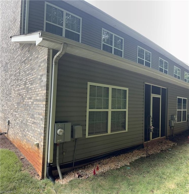 back of property featuring brick siding