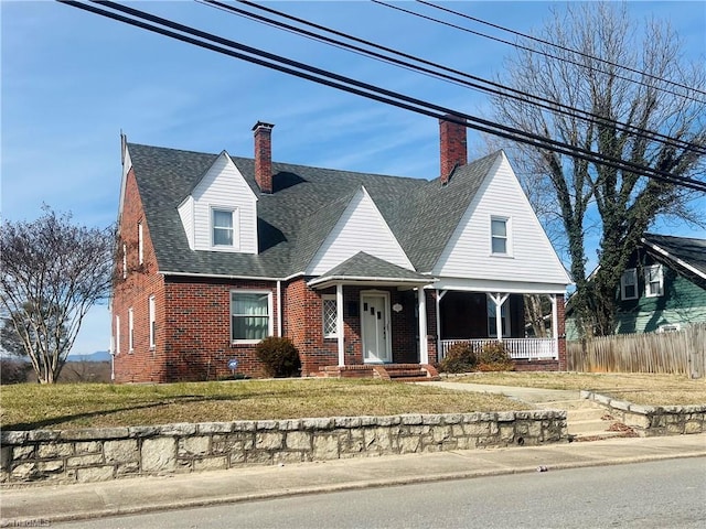 view of front facade featuring covered porch and a front lawn