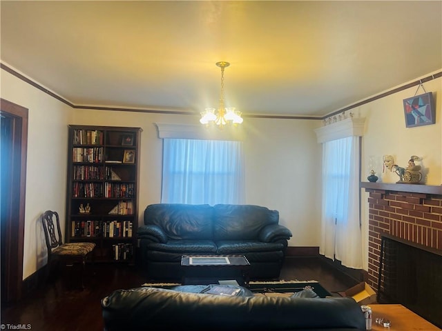 living room featuring a notable chandelier, a fireplace, and ornamental molding