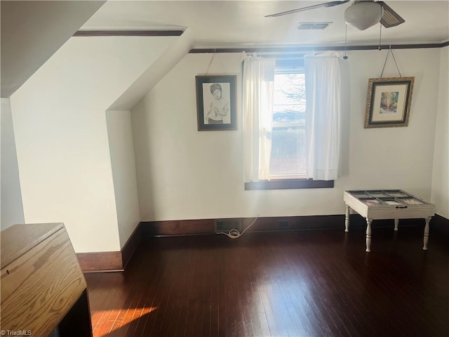 additional living space featuring dark wood-type flooring and ceiling fan