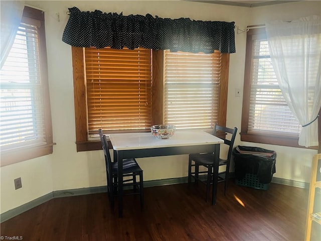 dining space with dark hardwood / wood-style flooring