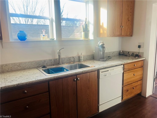 kitchen featuring dishwasher, sink, dark wood-type flooring, and light stone counters