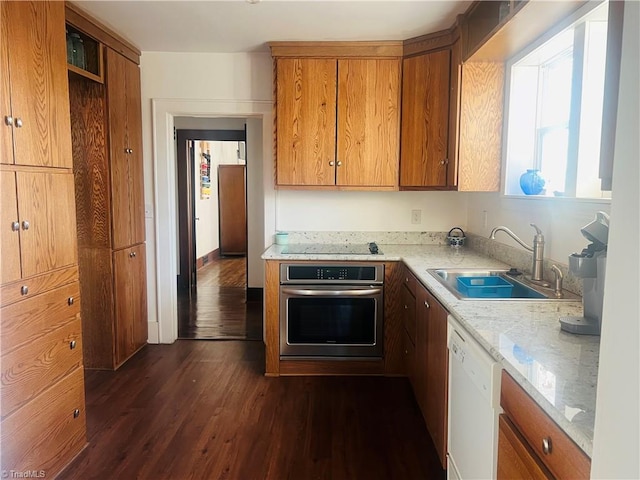 kitchen featuring sink, dark hardwood / wood-style flooring, white dishwasher, black electric stovetop, and oven