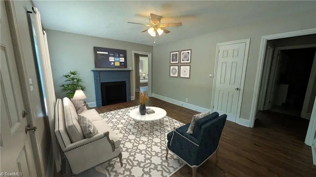 living room with dark wood-type flooring and ceiling fan