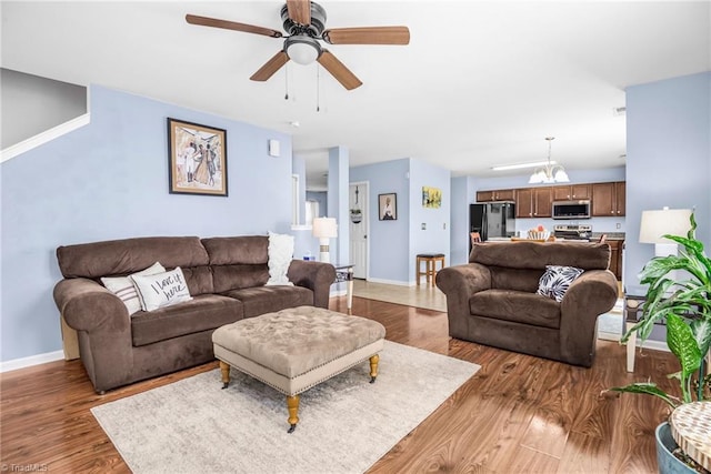 4385 Morning Ridge Ln, Winston-Salem, NC 27101 - living room featuring wood finished floors, ceiling fan, and a chandelier