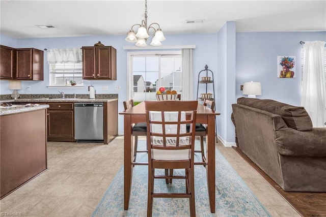 4385 Morning Ridge Ln, Winston-Salem, NC 27101 - kitchen with dishwasher, a chandelier, dark brown cabinets, and pendant lighting