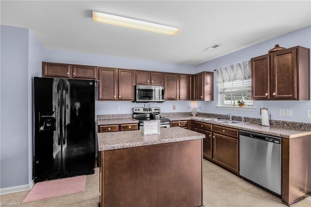 4385 Morning Ridge Ln, Winston-Salem, NC 27101 - kitchen featuring stainless steel appliances, a kitchen island, and dark brown cabinets