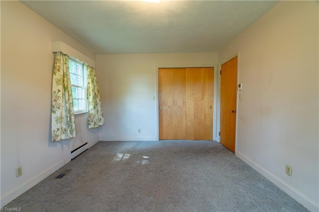 unfurnished bedroom with a closet, light carpet, and a baseboard radiator