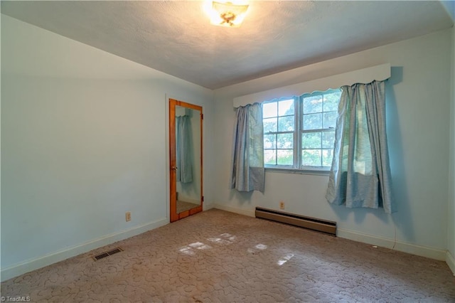 unfurnished bedroom with a closet and a baseboard heating unit