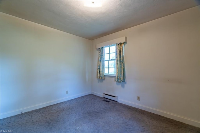 carpeted spare room featuring a baseboard radiator